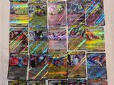 a pile of pokemon cards sitting on top of a table