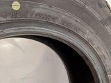 a close up of a tire with a yellow dot on it