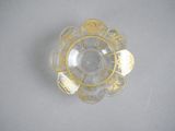 a small glass bowl with a gold design on it