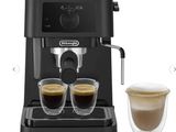 a black coffee machine with two cups of coffee next to it