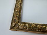 an image of a gold picture frame with ornate designs on it