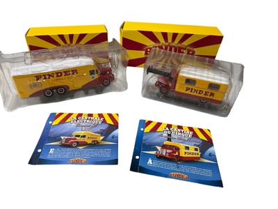 three toy trucks are sitting next to each other on a white surface