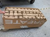 a box of bricks sitting on the ground next to a carton