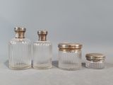 three glass jars with silver lids and a silver lid