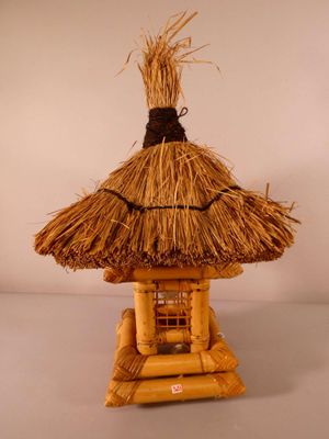 a small thatched hut with a thatched roof