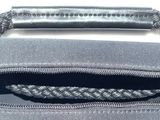 a gray bag with a black handle and a black handle