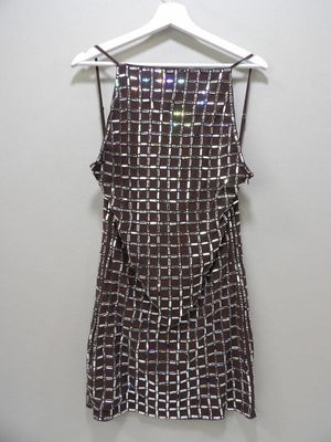 a brown and white dress hanging on a hanger on a wall