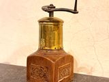 a small wooden bottle with a metal cap on it