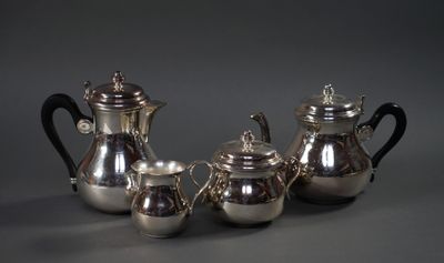 three silver teapots and a silver coffee pot on a table