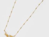 a gold plated necklace with a bird pendant and a beaded chain