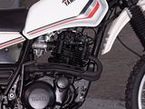 a white and red motorcycle parked in a parking lot
