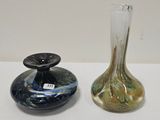 two glass vases sitting on top of a table next to each other