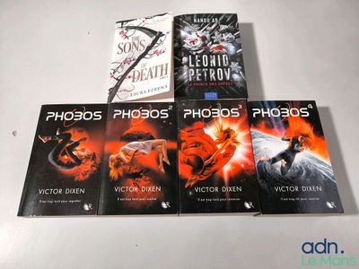 three books are sitting on a table next to each other