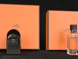 an image of a couple of perfume bottles sitting on top of a table