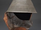 a helmet on a stand with a gray background