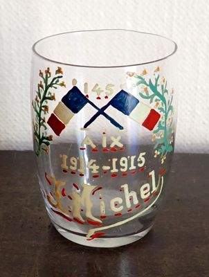 a glass with a picture on it sitting on a table