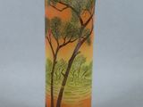 a vase with a painting on it sitting on a table