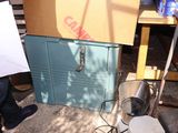 une boîte posée par terre à côté d'un ventilateur