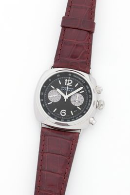 an image of a wrist watch with a black dial and red leather strap