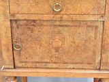 a small wooden cabinet with a drawer on top of it