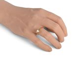 an image of a woman ' s hand with a gold ring on it