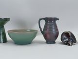three vases and a bowl sitting next to each other
