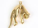 two gold cat charms with diamonds on a white background