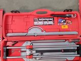 a red tool box with tools in it on the floor