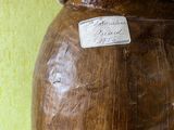 a wooden vase that has a label on it