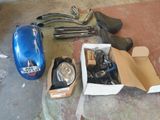 a box of tools sitting on the floor next to a blue car