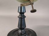 an antique globe on a metal stand with a white background