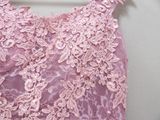 a close up of a pink dress on a hanger