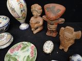 many different types of pottery on a black table