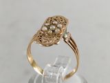 an image of a close up of a ring with pearls on it