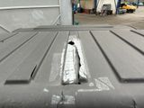 an image of a truck bed with a piece of metal on it