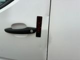 a door handle on a white car with a sticker on it