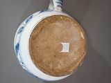 a blue and white vase with a white stripe on it