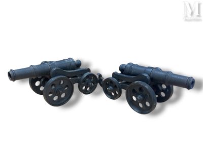 two black cannon wheels on wheels on a white background