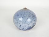 a blue and white vase on a white surface