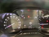 a close up of a car dashboard with various gauges