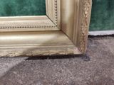 a picture of a gold frame on the ground