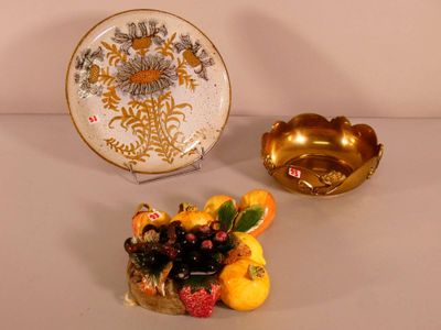 a plate and a bowl of fruit sitting on a table