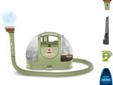 un gros plan d'un aspirateur muni d'un tuyau et d'un vaporisateur