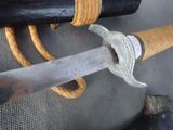 a close up of a knife with a rope on it