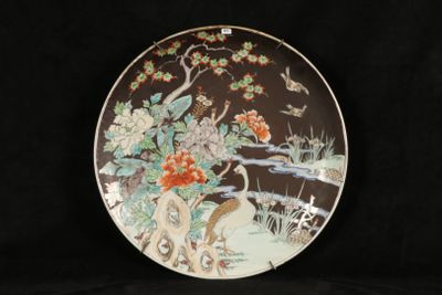 an image of a decorative plate with a bird and flowers on it