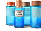 several bottles of blue liquid are lined up on a white surface