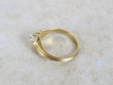 a close up of a gold ring with a diamond on it