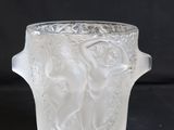 a glass vase with a handle on a black background