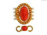 une image représentant une pierre rouge sertie dans une broche en or