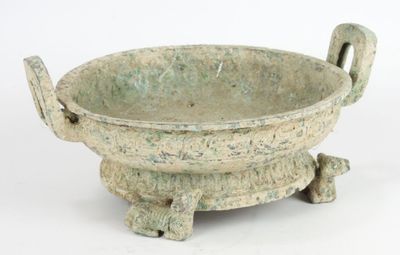 a small green bowl with handles on a stand